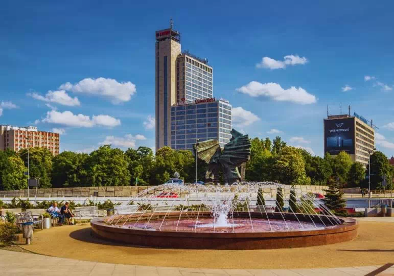 Mężczyźni siedzący naprzeciw fontanny Katowice