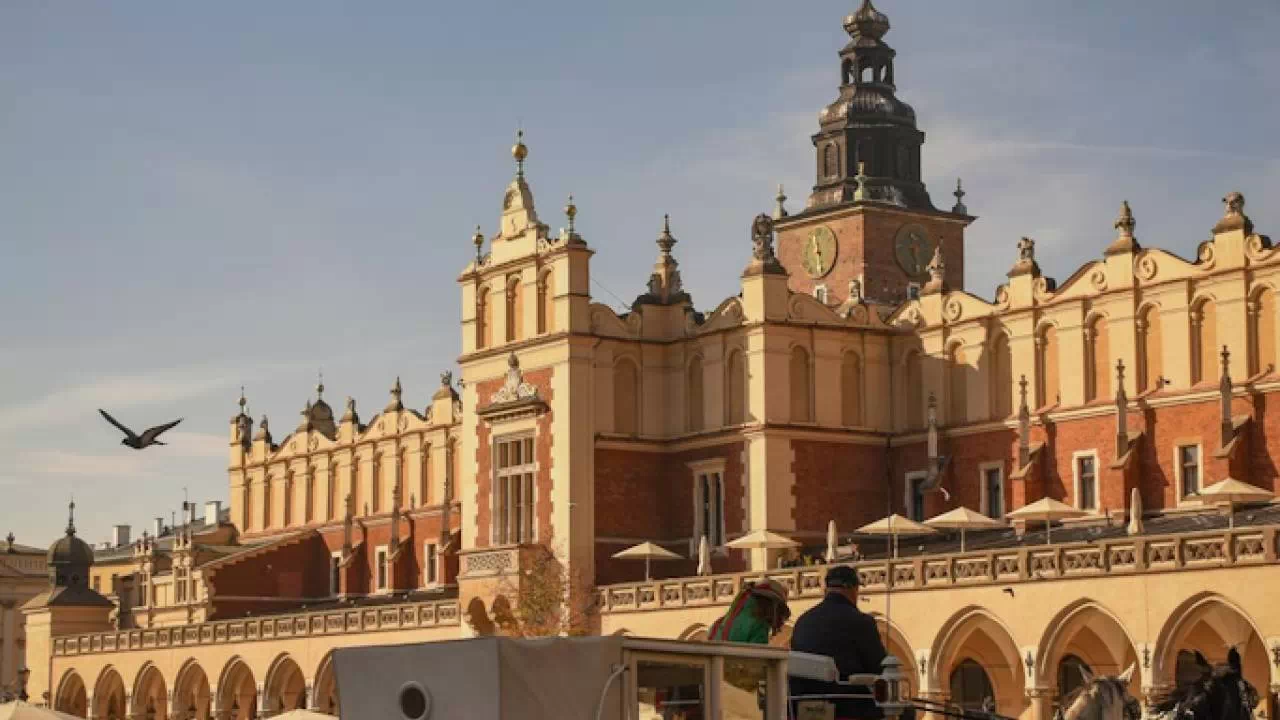 Krakowskie Sukiennice i dorożka z końmi na rynku